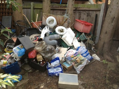 Muck away service vehicle removing debris